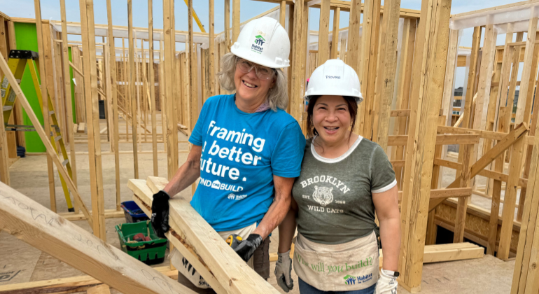 Sue smiles for a photo with a volunteer she was leading and teaching for the day on site in Calgary.