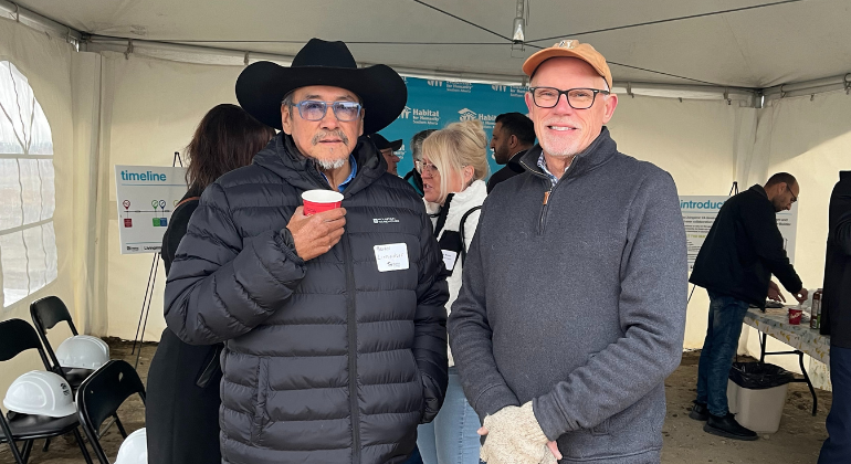 Russ stands with Elder Brian Littlechief at a Habitat groundbreaking event.