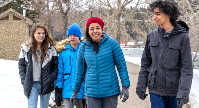 Future homeowner Mildred walks in Calgary's Edworthy Park with her 3 teenage children