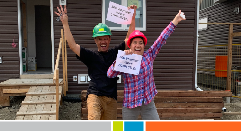 A couple celebrating completing their volunteer hours on a Habitat build site