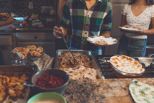 person-picking-food-on-tray-1631893