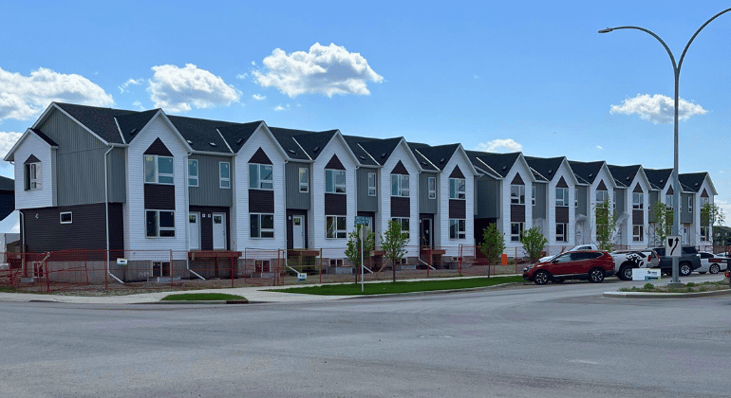 A row of nearly completed Habitat townhomes under construction
