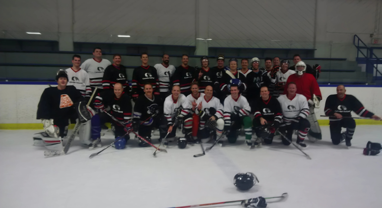 A hockey team group photo on a hockey rink