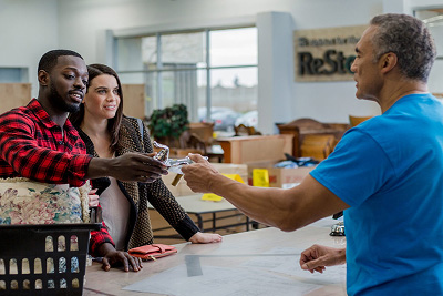 A couple making a purchase at ReStore.