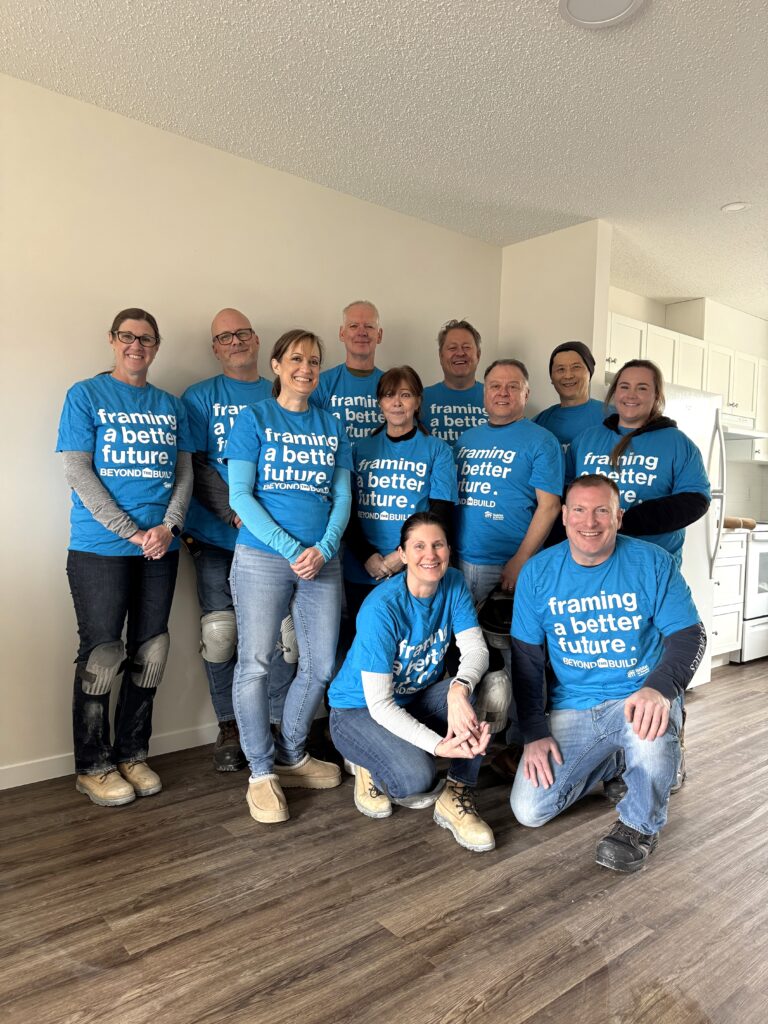 A group of volunteers inside a nearly finished Habitat home