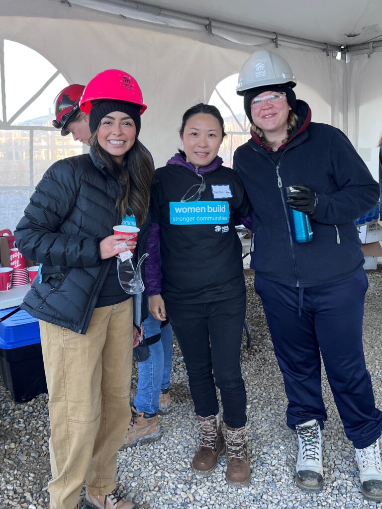 Three women in an event tent on a construction site