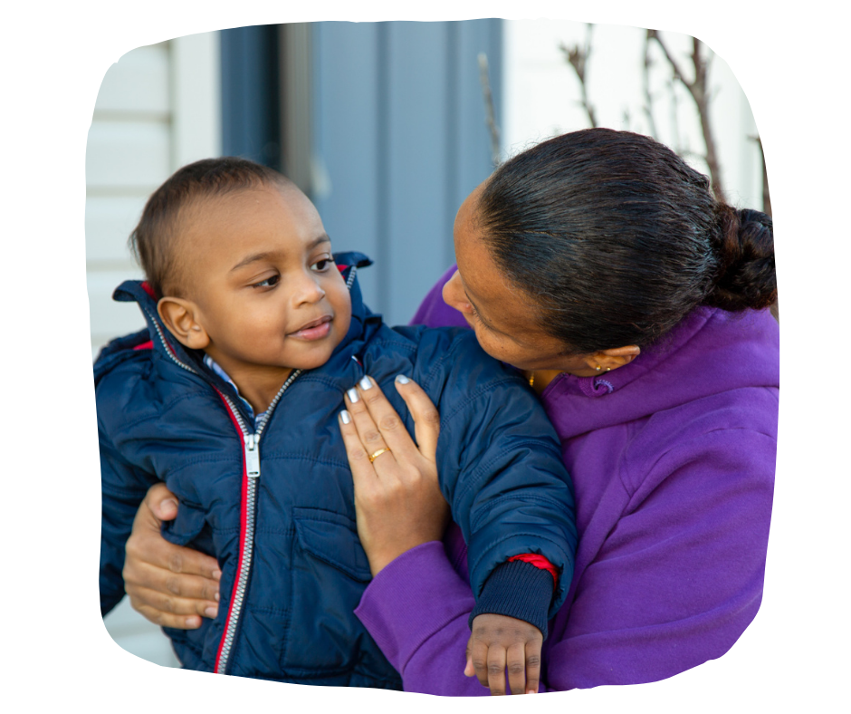 Mother Yikalo plays with her infant son on their new front porch.