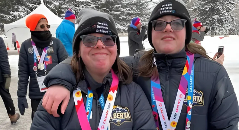 Susan and her twin sister pose with their winning medals. 