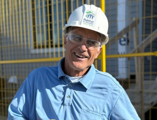 Volunteer Crew Leader Jeff wearing his white Habitat hardhat on site.