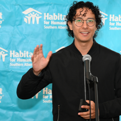 Santiago smiles while delivering a speech at a Habitat home event.