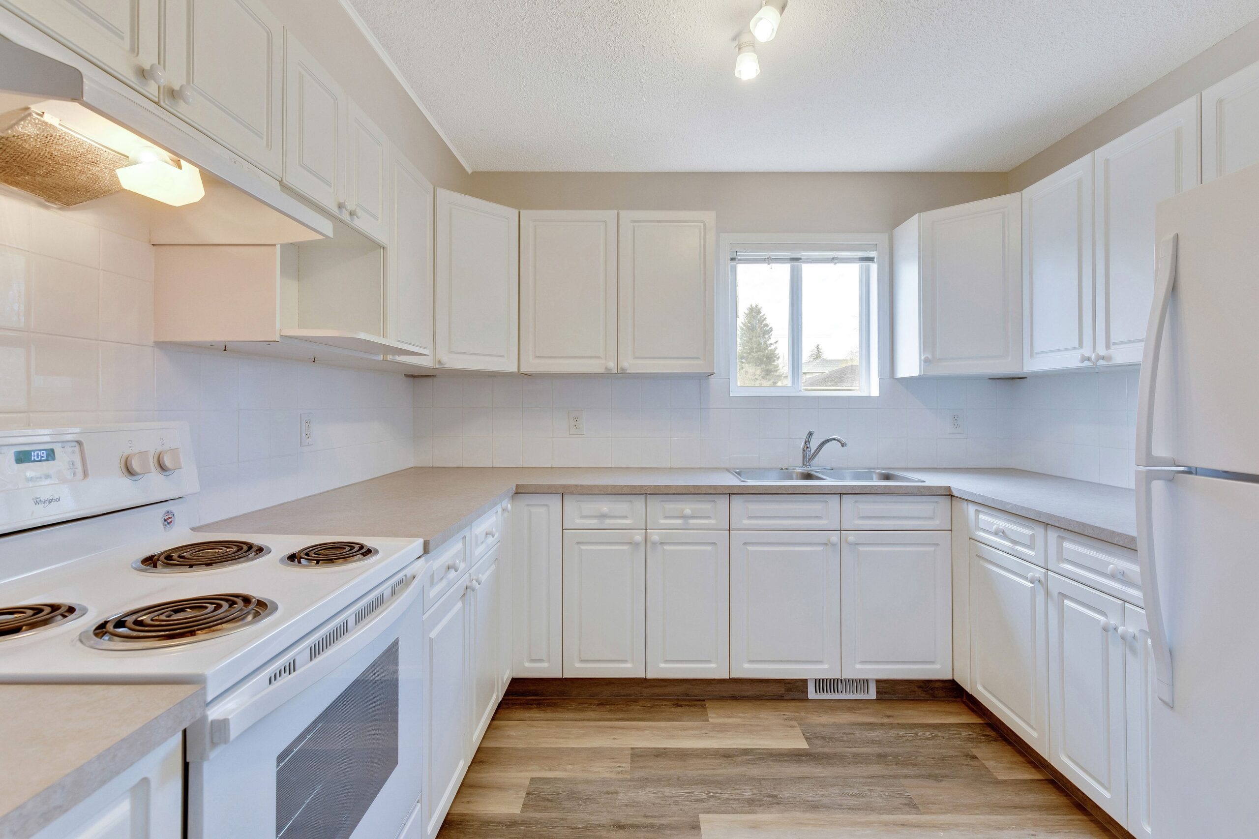 All white kitchen in a Habitat home in Calgary.