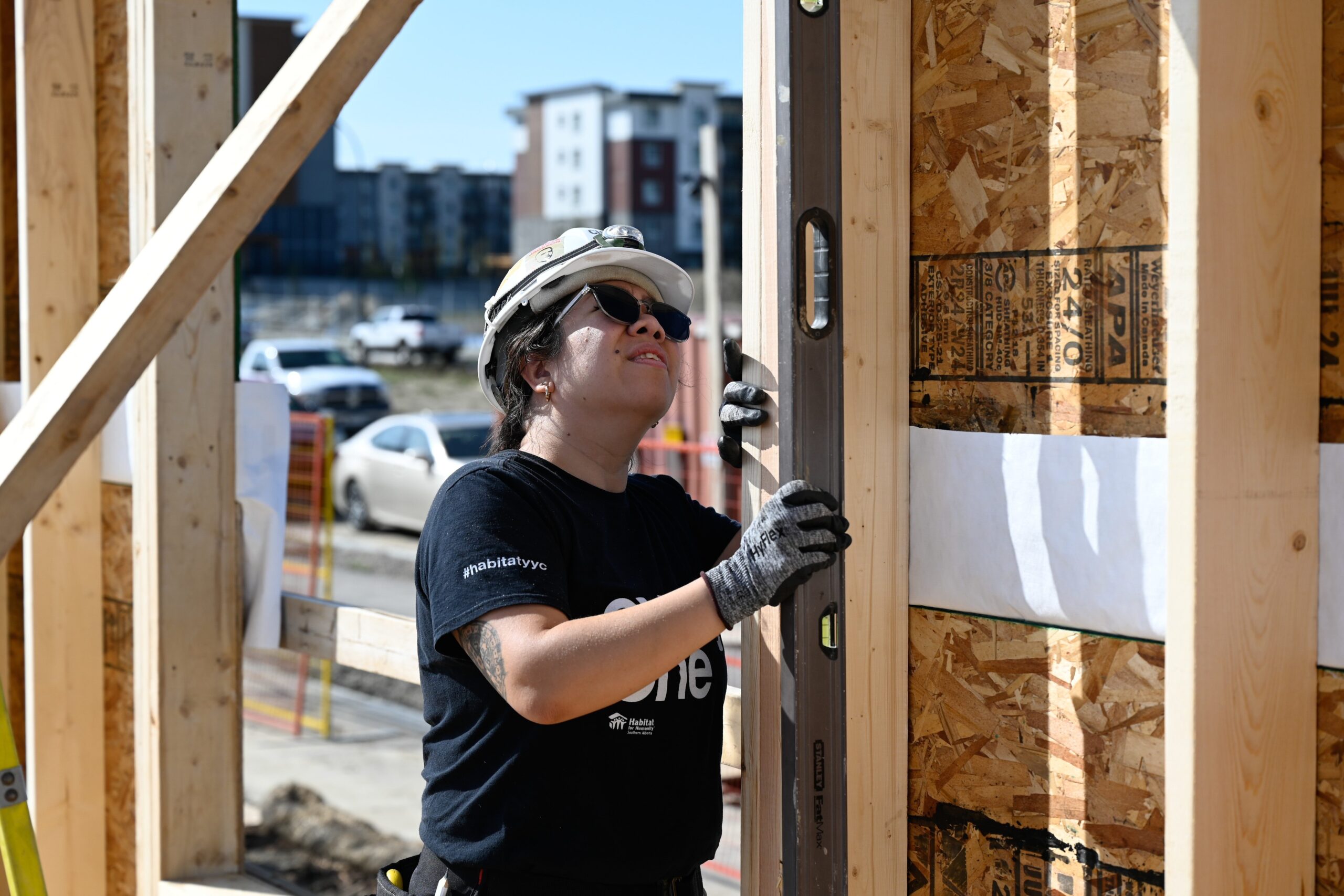 Volunteer Ctew Leader Charissa inspects an newly installed exterior wall.