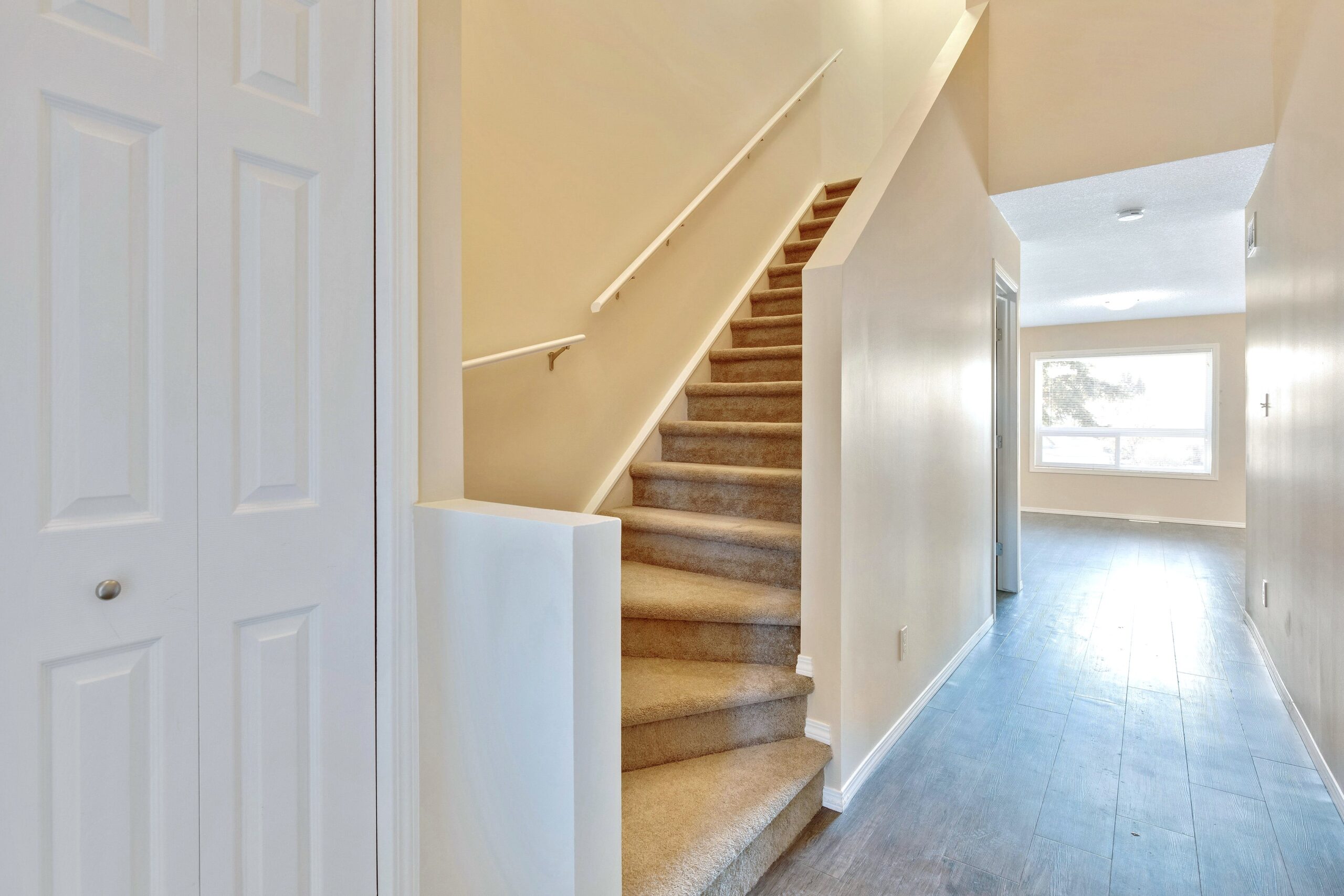Interior photo showing the open concept and stairs of a Habitat home in Cochrane.