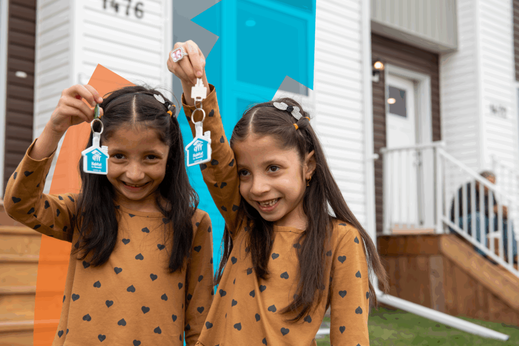 2023 Annual report title image of twin girls show off their new house keys.