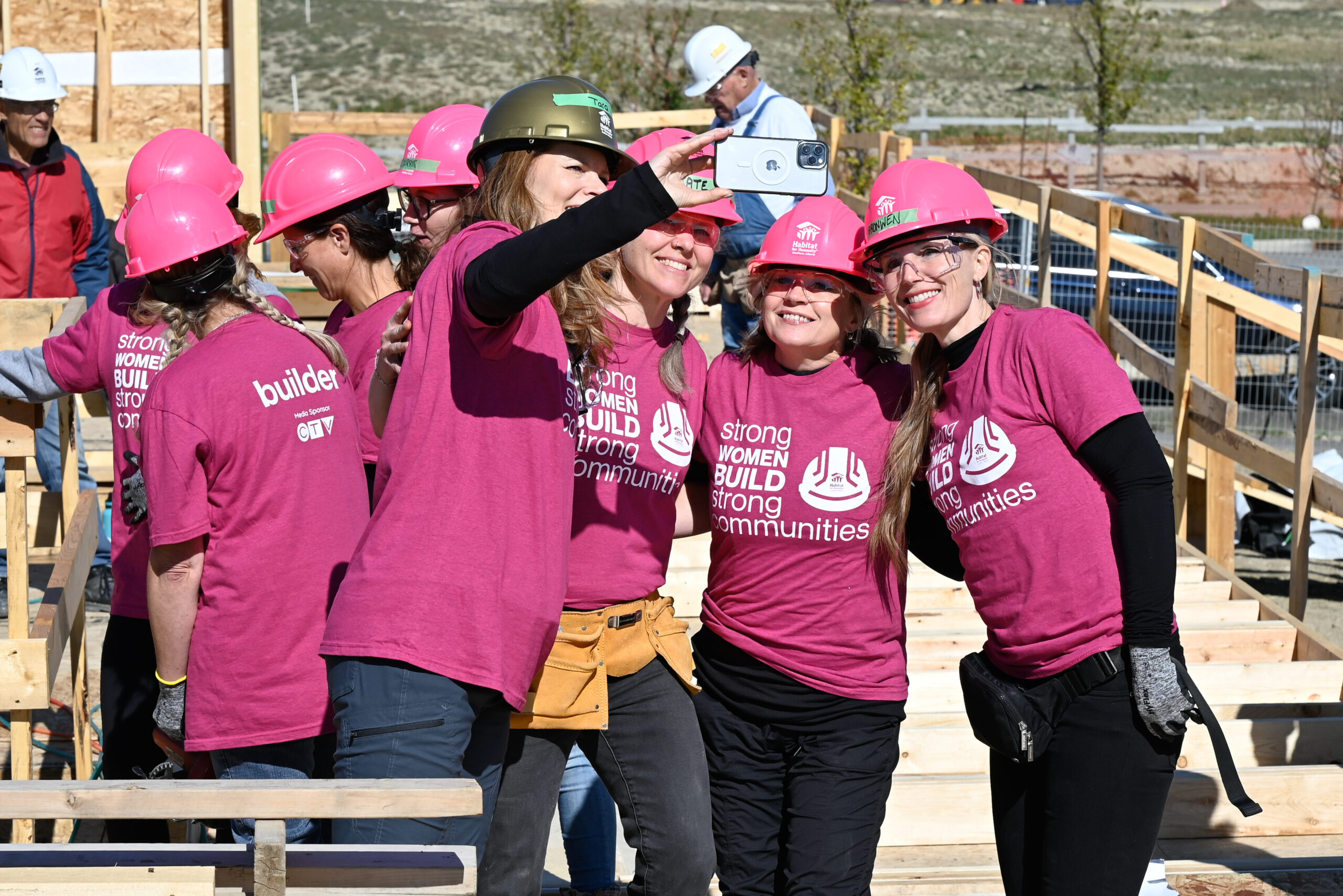 Tara Nelson taking a selfie with her friends on a construction site