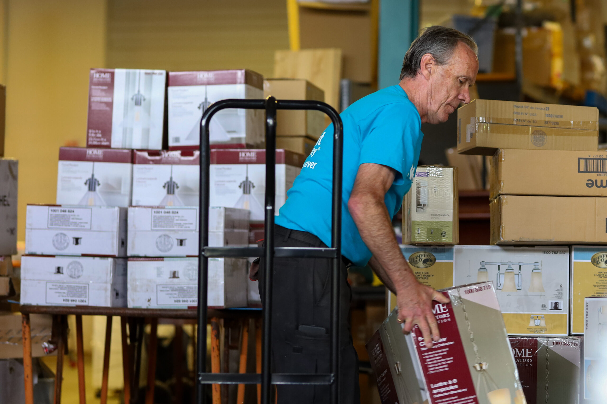 A volunteer unloads a corporate donation in a ReStore warehouse.