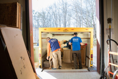 Two ReStore employees unload a truck