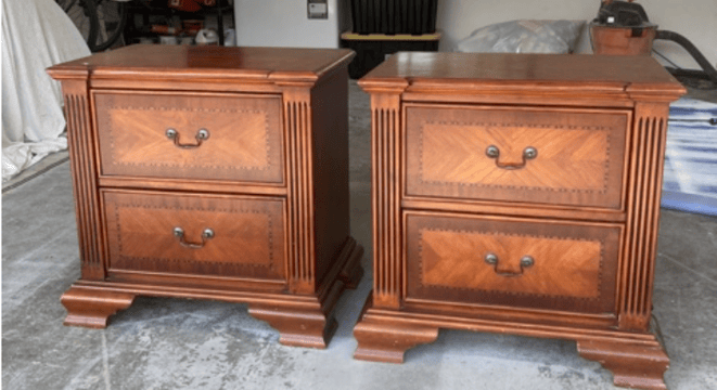 two matching nightstands in a dark coloured stain, with fluted details and ornate pewter handles