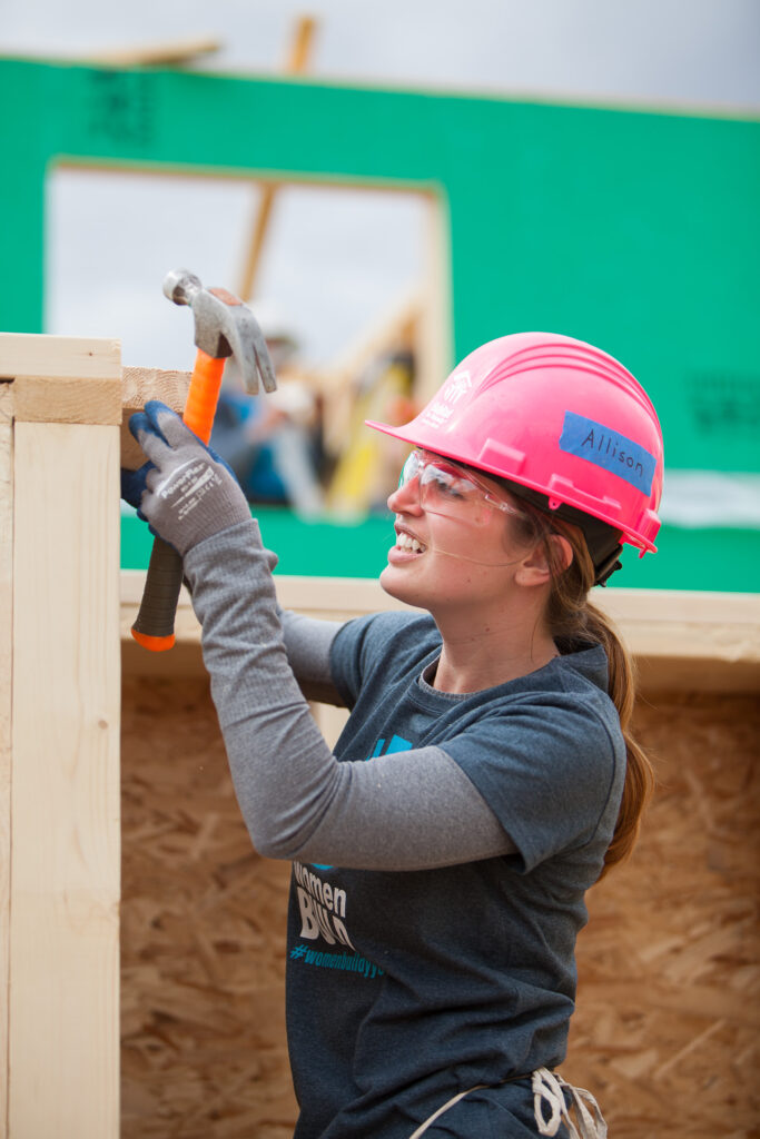 Women holding a hammer on a construction site