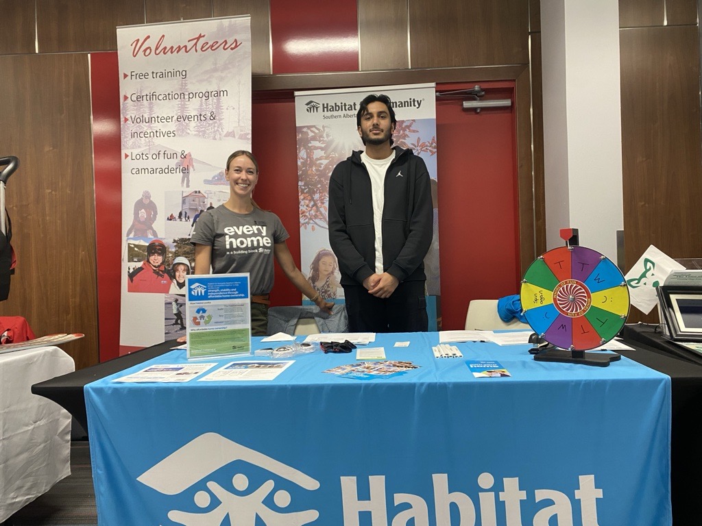 Volunteer Rehman and Habitat manager Lauren staff a booth at a community event. 
