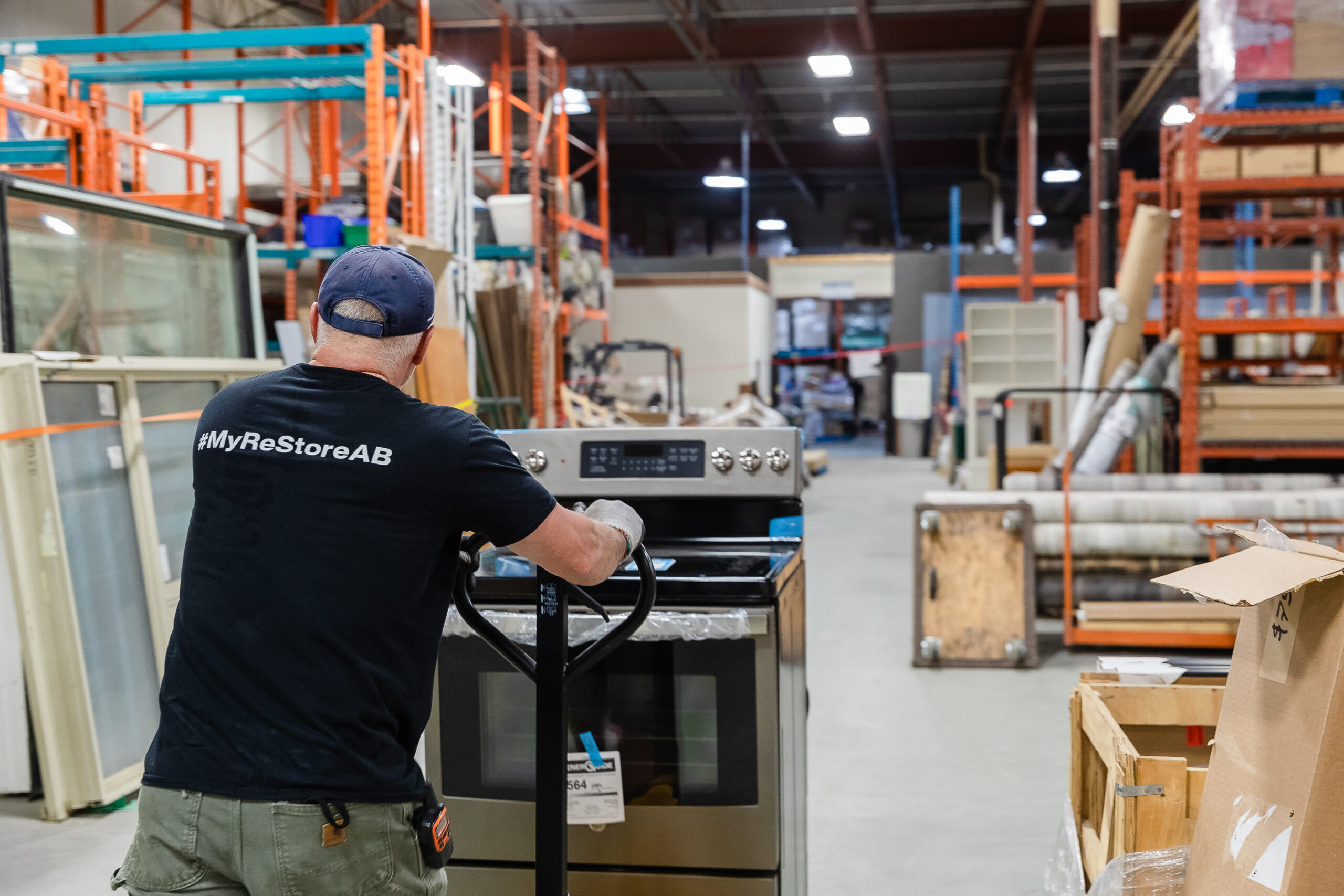 Staff moving range using a dolly. Habitat ReStore in Calgary, Alberta