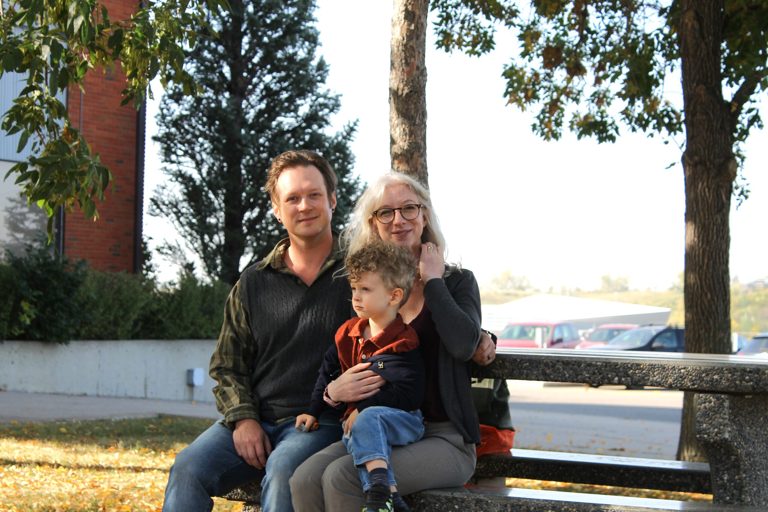 Pamela and Joel sit at a picnic table at the Habitat offices.