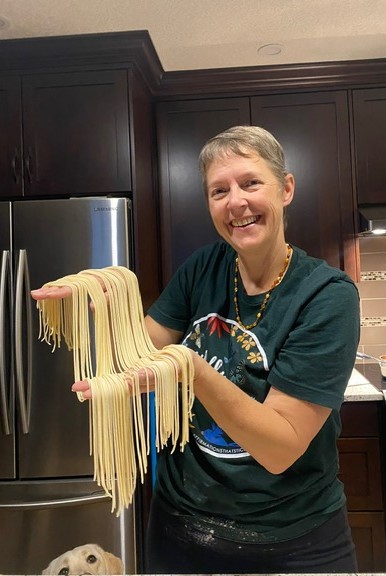 Volunteer Bev making pasta.