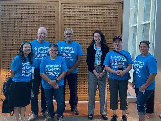 Medicine Hat Chapter volunteers wearing matching Habitat blue shirts that say 'building brigher futures".