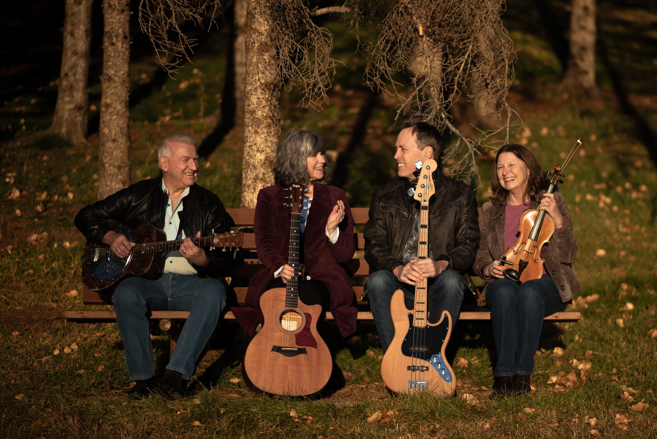 Steve with three band members and their string instruments.