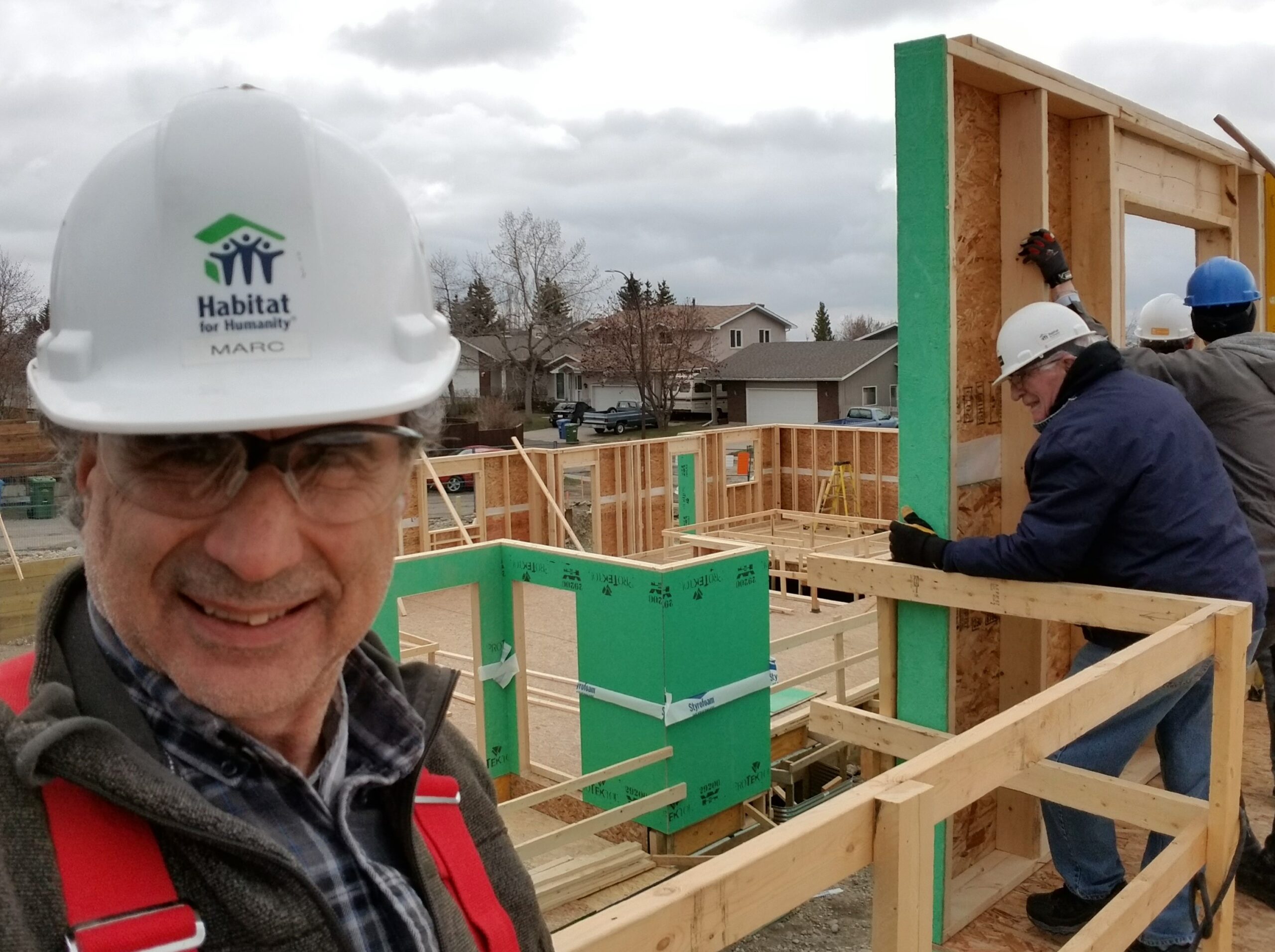Marc takes a selfie on the second story of an unframed townhome.