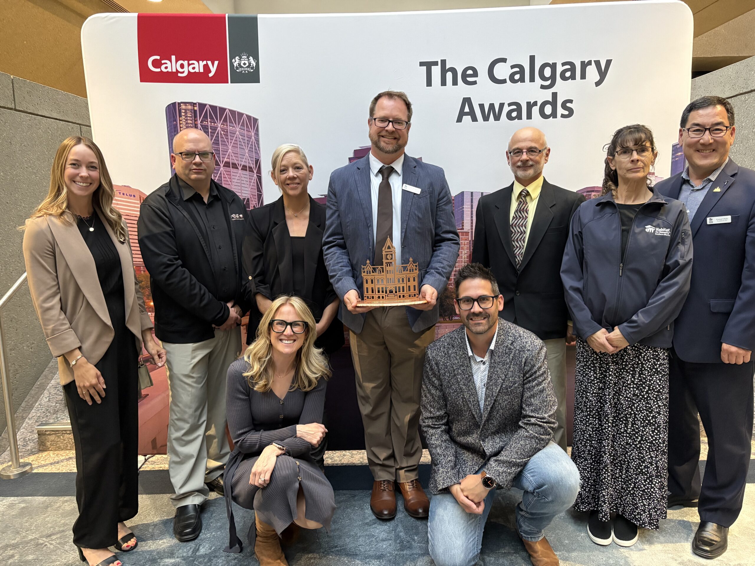 Habitat Southern Alberta staff pose with a trophy at the Calgary Awards.