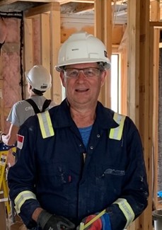 Mario wearing a white hardhat and infamous blue coveralls.