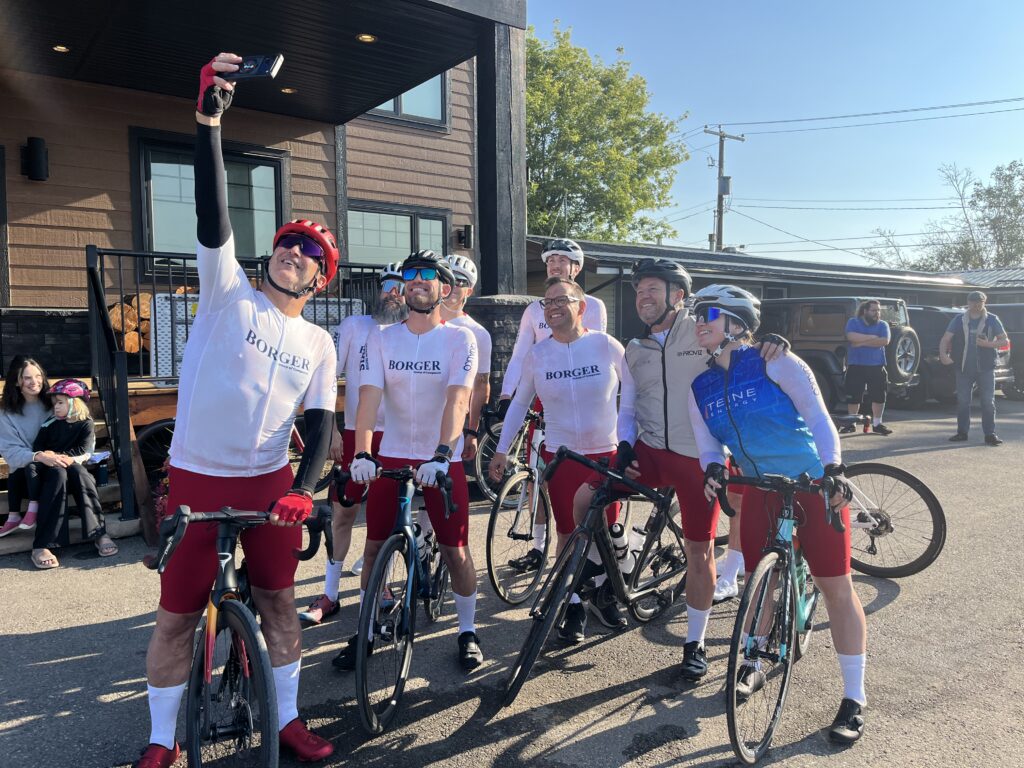Five cyclists take a candid photo together.