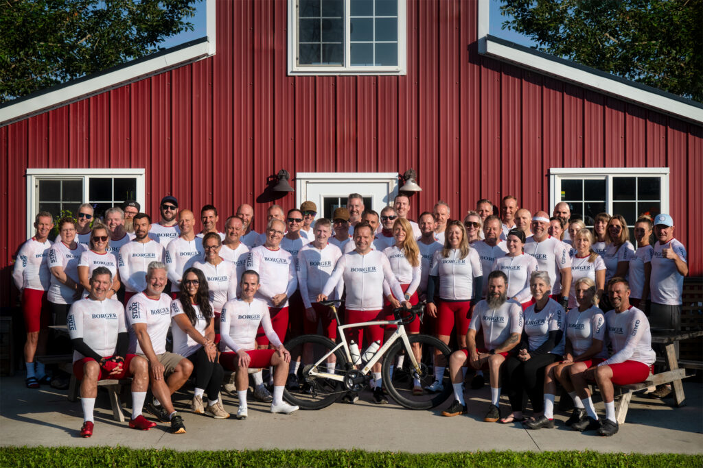 Group photo in front of a red barn