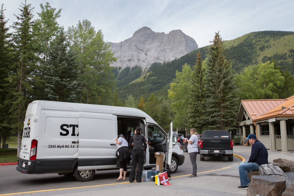 White van in mountain parking lot.