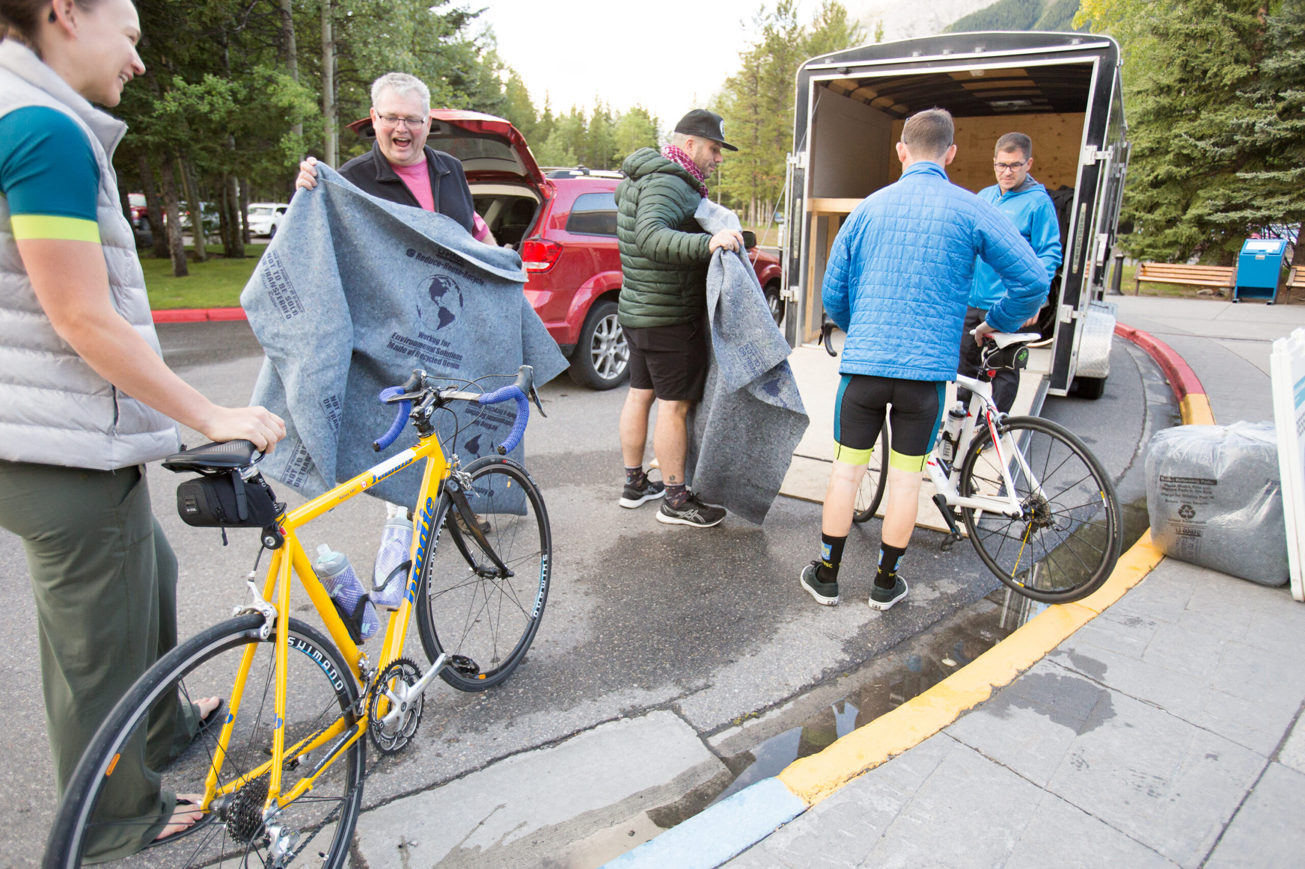 Volunteers load bikes into a trailer.