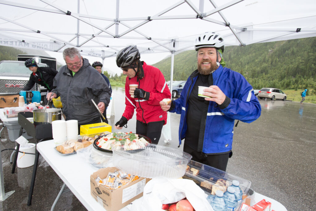 Cyclists stop at a rest stop for snacks.